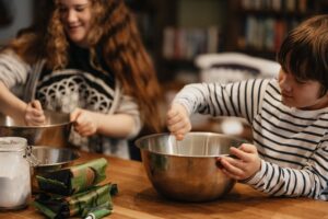 Children stirring flour for baked goods